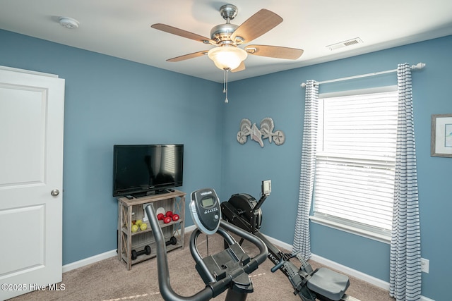 exercise area with carpet, visible vents, baseboards, and a ceiling fan