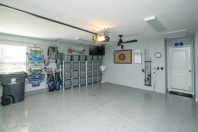 garage with ceiling fan and a garage door opener