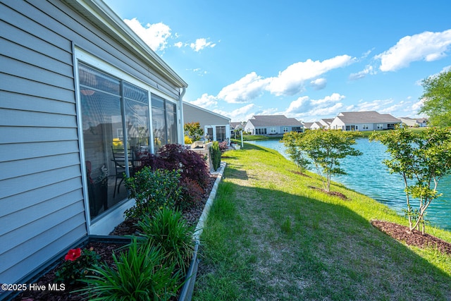 view of yard featuring a water view and a residential view