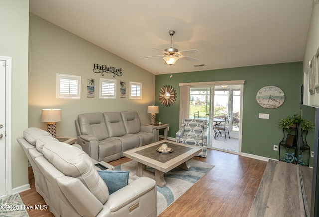 living area featuring wood finished floors, ceiling fan, baseboards, and visible vents