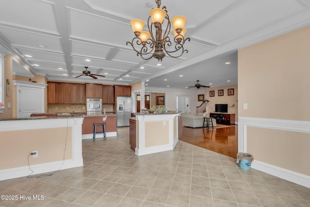 3400 Canmorre Ct, Fayetteville, NC 28306 - kitchen featuring open floor plan, a center island, stainless steel fridge, and ceiling fan with notable chandelier