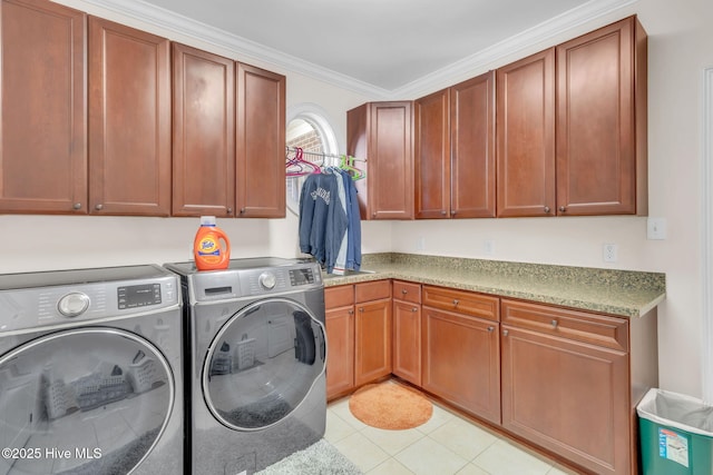 3400 Canmorre Ct, Fayetteville, NC 28306 - laundry room with light tile patterned floors, ornamental molding, cabinet space, and washer and clothes dryer