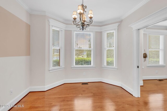 3400 Canmorre Ct, Fayetteville, NC 28306 - unfurnished dining area with crown molding, visible vents, a chandelier, light wood finished floors, and baseboards