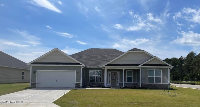 craftsman-style house with a garage, driveway, stone siding, and a front lawn