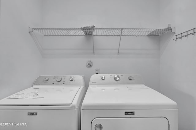 clothes washing area featuring laundry area and washing machine and clothes dryer