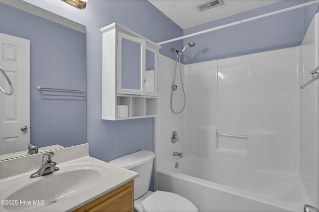 full bathroom featuring vanity, a textured ceiling, toilet, visible vents, and tub / shower combination