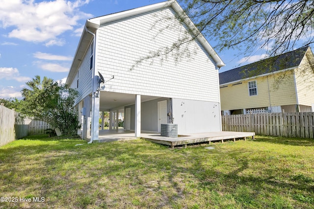 rear view of house featuring a patio area, central AC unit, a fenced backyard, and a lawn