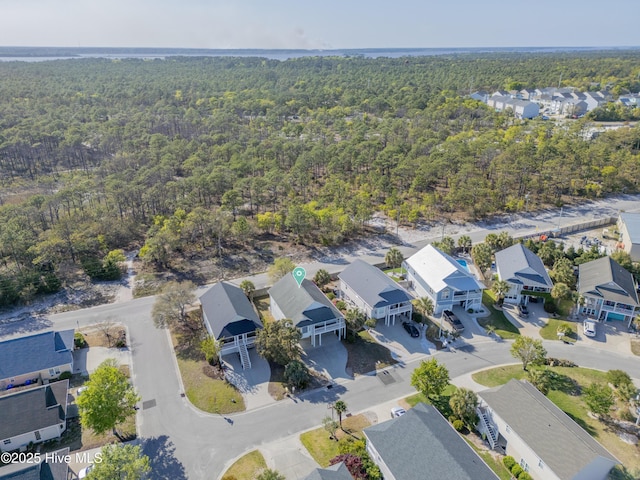 bird's eye view featuring a forest view and a residential view