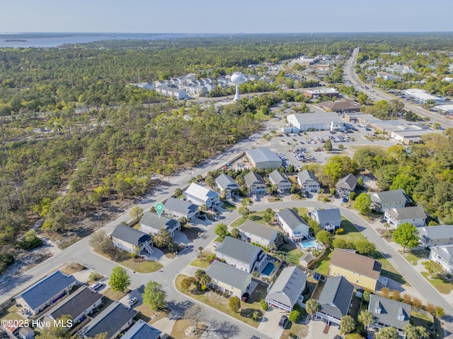 drone / aerial view featuring a residential view and a forest view
