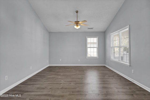 unfurnished room with visible vents, baseboards, a ceiling fan, dark wood finished floors, and lofted ceiling