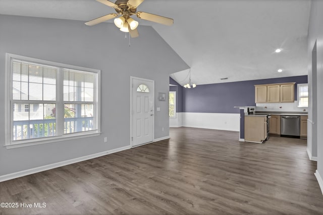 unfurnished living room featuring ceiling fan with notable chandelier, high vaulted ceiling, recessed lighting, dark wood-style flooring, and baseboards