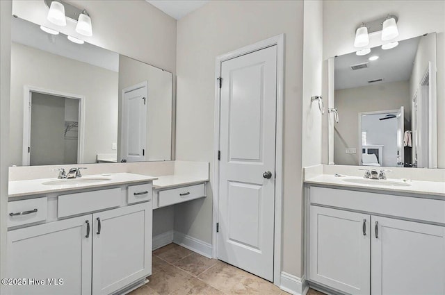 full bathroom featuring a sink, two vanities, a closet, and visible vents