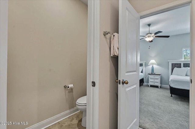 ensuite bathroom featuring toilet, ensuite bathroom, baseboards, and a ceiling fan