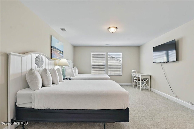 carpeted bedroom featuring baseboards and visible vents