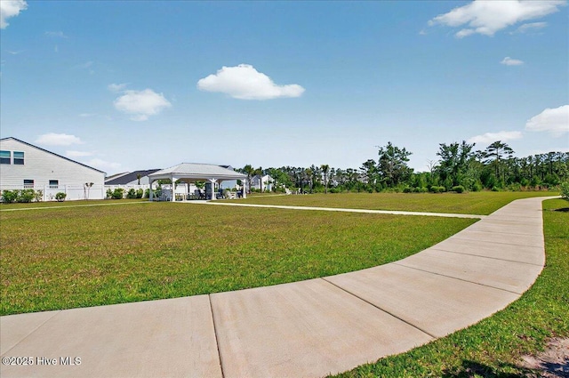 view of home's community with a gazebo, a carport, and a lawn