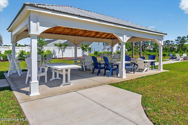 surrounding community featuring fence, a gazebo, a lawn, and a patio area
