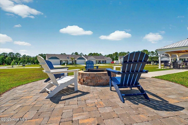 view of patio featuring a fire pit and a gazebo