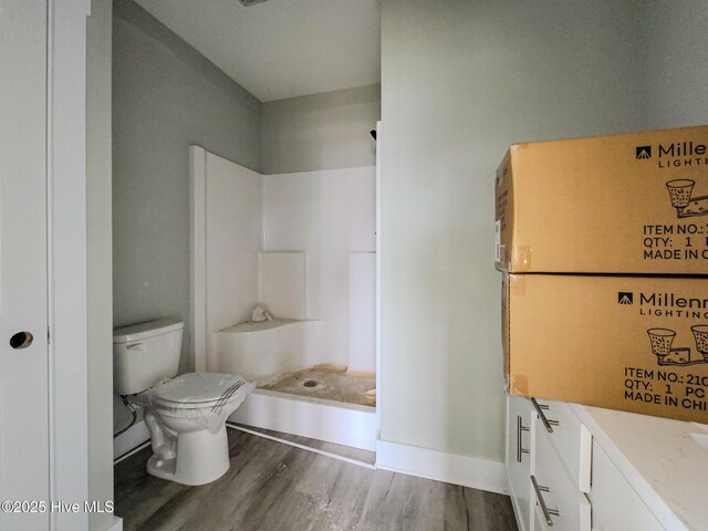 706 N New River Dr, Surf City, NC 28445 - full bath featuring toilet, wood finished floors, and walk in shower
