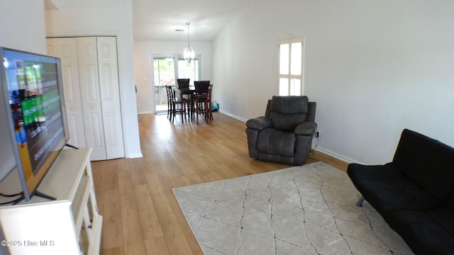 sitting room with baseboards and light wood finished floors