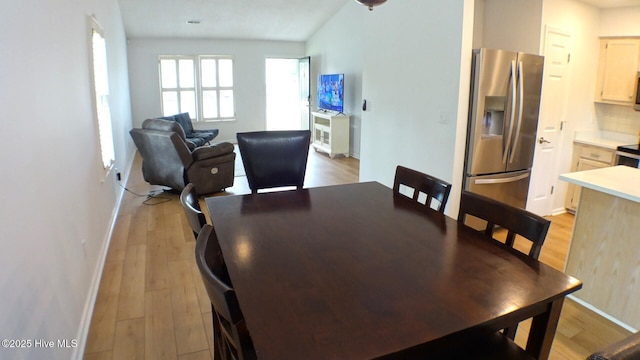 dining room featuring light wood-style floors and baseboards