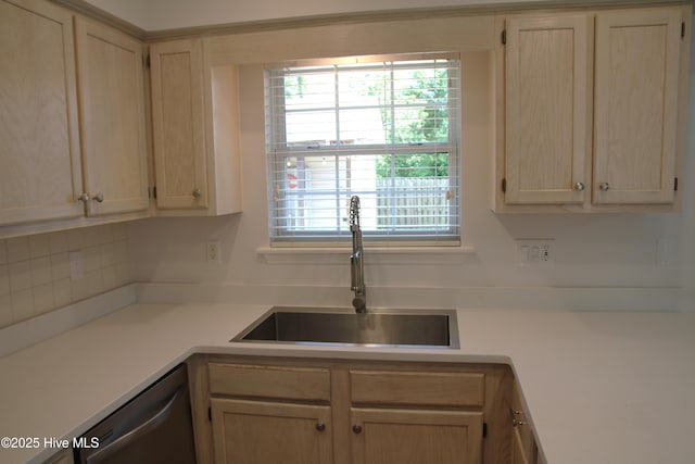 kitchen with a sink, light brown cabinetry, dishwasher, and tasteful backsplash