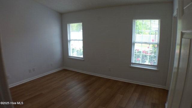 empty room featuring baseboards and wood finished floors