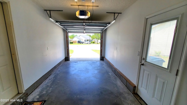 garage featuring baseboards and a garage door opener