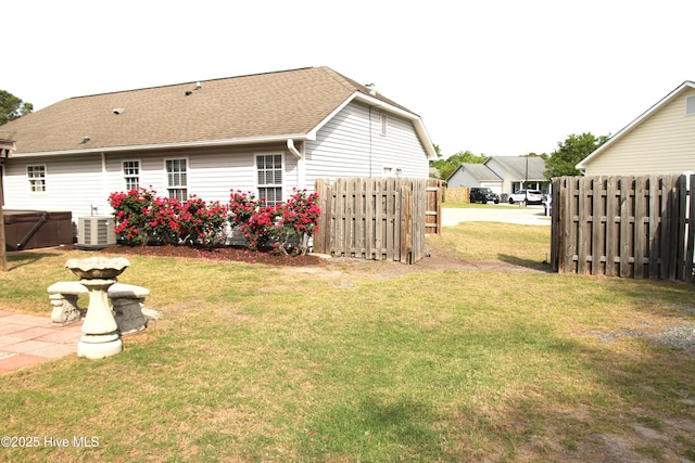 view of yard featuring fence and cooling unit