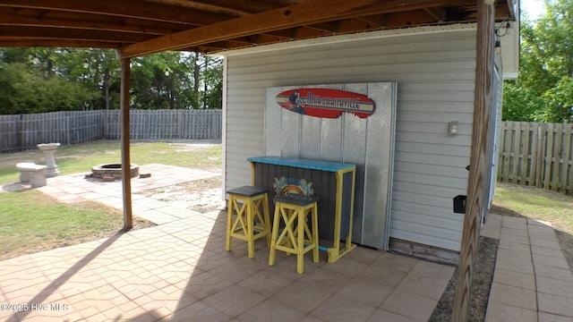 view of patio with a fenced backyard and an outdoor fire pit