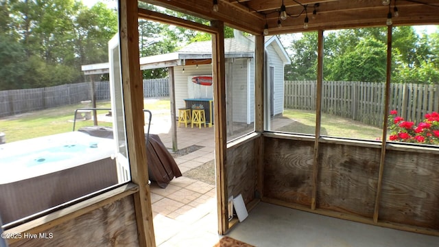 unfurnished sunroom with a jacuzzi
