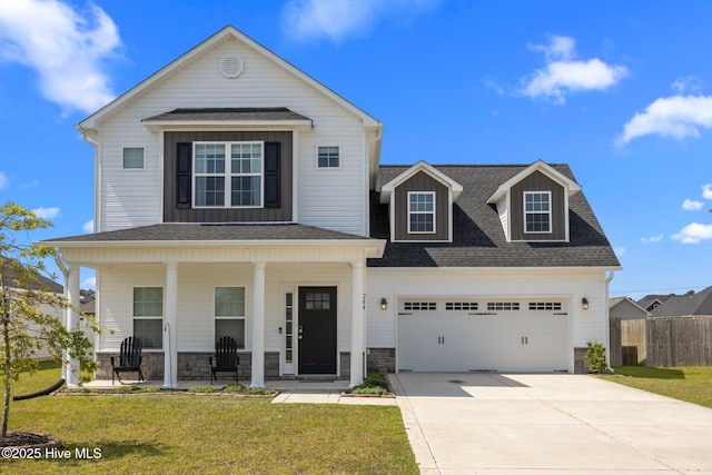 view of front of property with a porch, fence, concrete driveway, and a front yard