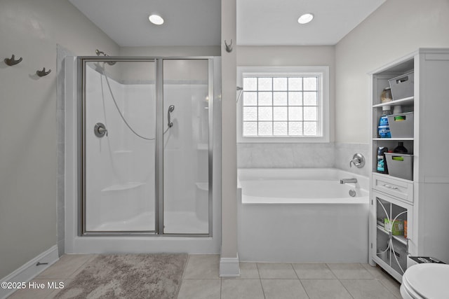 full bath with tile patterned flooring, a stall shower, toilet, and a garden tub