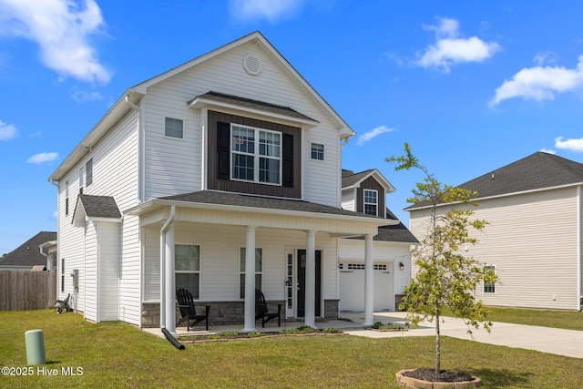 traditional-style home with fence, a front lawn, stone siding, concrete driveway, and covered porch
