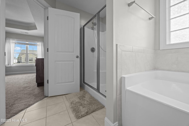 full bath with a garden tub, tile patterned flooring, a stall shower, and a tray ceiling