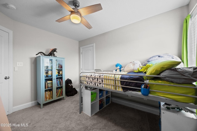 bedroom with a ceiling fan, baseboards, and light carpet