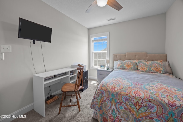 carpeted bedroom featuring baseboards, ceiling fan, and visible vents