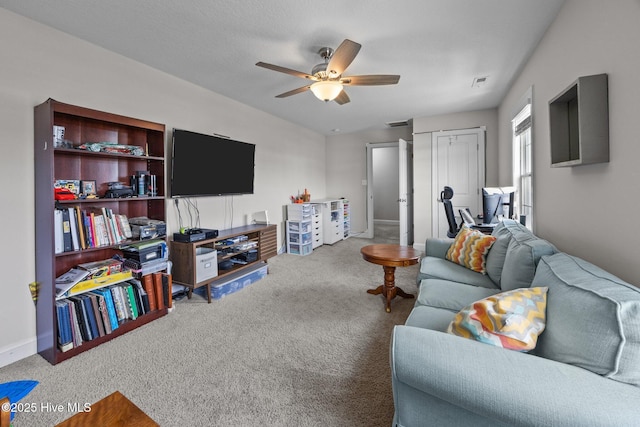 carpeted living room featuring ceiling fan, visible vents, and baseboards