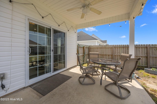 view of patio / terrace featuring fence, outdoor dining area, and ceiling fan
