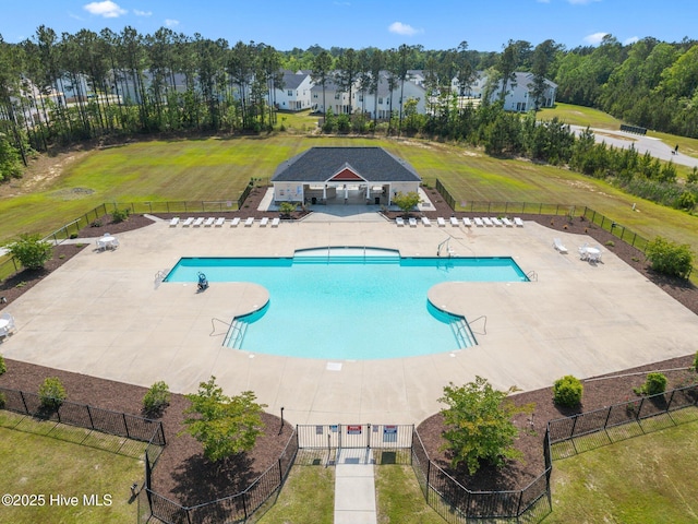 community pool with fence and a patio