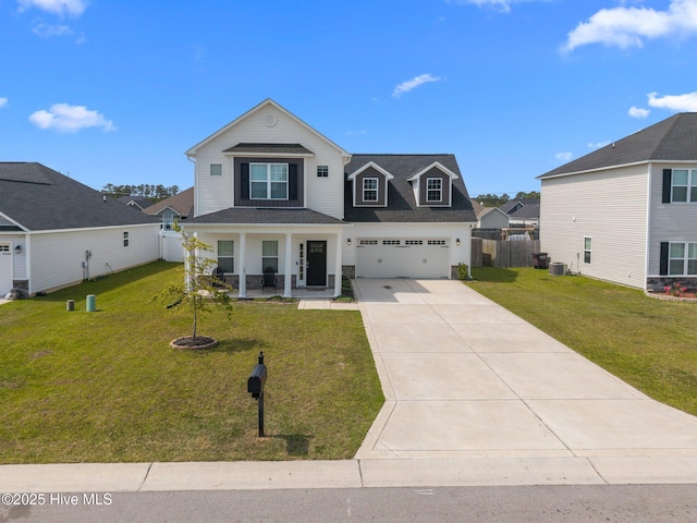 traditional-style home with fence, a front yard, central AC unit, concrete driveway, and covered porch