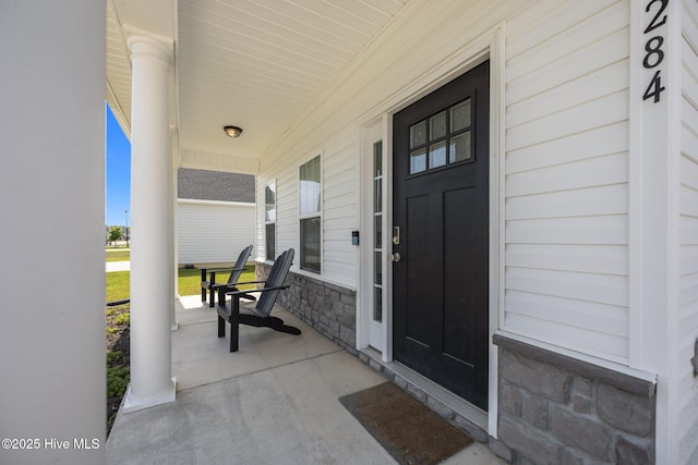 view of exterior entry with covered porch