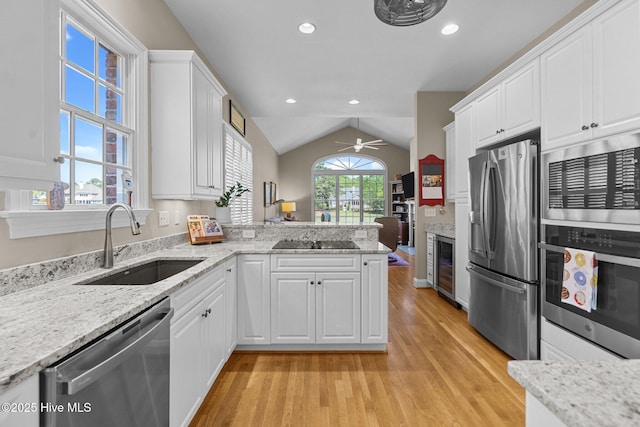 423 Black Diamond Dr, Wilmington, NC 28411 - kitchen with light wood-type flooring, a ceiling fan, appliances with stainless steel finishes, beverage cooler, and a sink