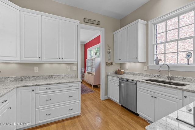 423 Black Diamond Dr, Wilmington, NC 28411 - kitchen with light wood-style floors, stainless steel dishwasher, white cabinetry, light stone counters, and a sink