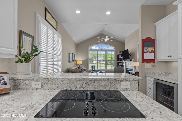 423 Black Diamond Dr, Wilmington, NC 28411 - kitchen featuring lofted ceiling, white cabinetry, a ceiling fan, black electric cooktop, and wine cooler