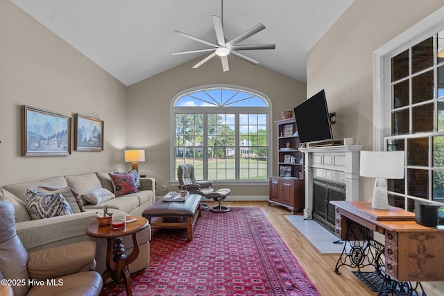 423 Black Diamond Dr, Wilmington, NC 28411 - living room featuring vaulted ceiling, light wood-type flooring, a ceiling fan, and a premium fireplace