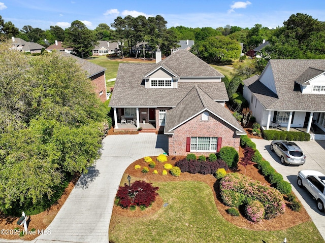 423 Black Diamond Dr, Wilmington, NC 28411 - traditional home featuring a shingled roof, a chimney, a front lawn, a residential view, and driveway