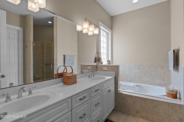 423 Black Diamond Dr, Wilmington, NC 28411 - bathroom featuring a stall shower, a garden tub, double vanity, and a sink