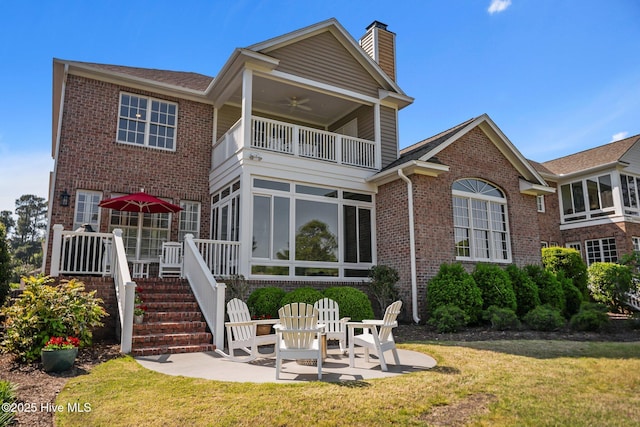 423 Black Diamond Dr, Wilmington, NC 28411 - back of property featuring a balcony, a patio area, brick siding, ceiling fan, and a sunroom