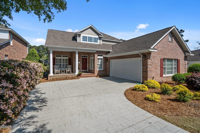 423 Black Diamond Dr, Wilmington, NC 28411 - view of front of home featuring a garage, covered porch, brick siding, a shingled roof, and driveway