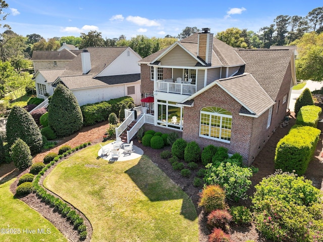 423 Black Diamond Dr, Wilmington, NC 28411 - exterior space with a front yard, a chimney, a patio, a balcony, and brick siding
